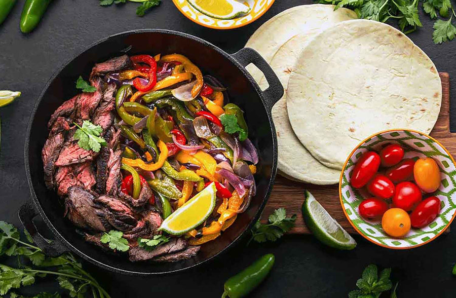 Pre cut pieces of beef, perfect for making fajitas! Cast Iron Skillet with fajita meat with sauteed peppers and onions.